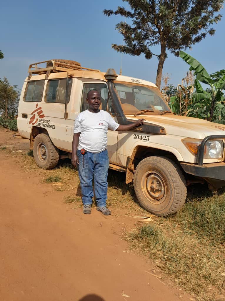 Bonnet Kamate Kihugo standing in front of an MSF car