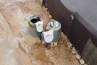 Aerial photo of 2 MSF Team members setting up water collection tanks.