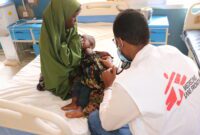 MSF Physician Doctor Ahmed Ilyas examining baby Saidya at MSF supported BRH in Baidoa, SW State, Somalia