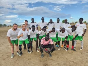 Football Team dressed in white shirts with MSF logo and green shorts comprising of MSF staff and community members during the multi-day football tournament in the Abyei Special Administrative Area, South Sudan.