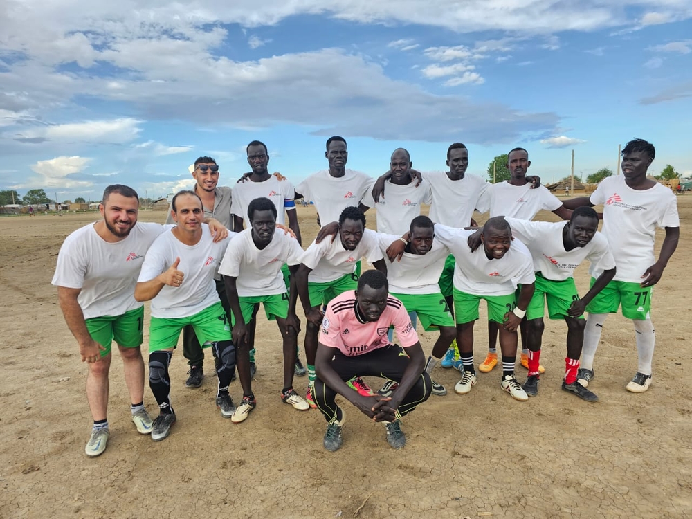 Football Team dressed in white shirts with MSF logo and green shorts comprising of MSF staff and community members during the multi-day football tournament in the Abyei Special Administrative Area, South Sudan.