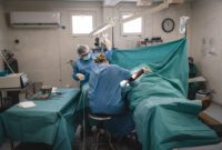 Two doctors undertaking an emergency surgery on a patient at MSF's Tabarre hospital in Port-au-Prince.