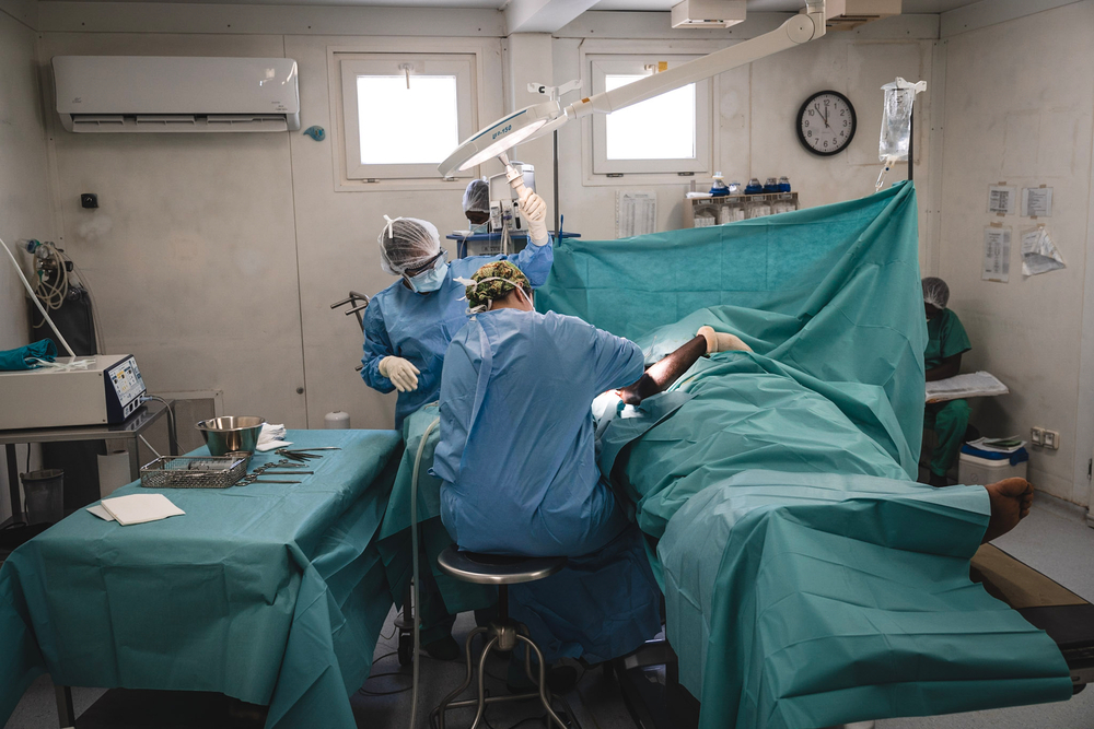 Two doctors undertaking an emergency surgery on a patient at MSF's Tabarre hospital in Port-au-Prince.
