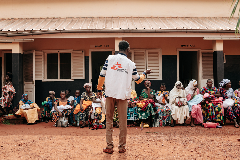 An MSF health promoter talking to a group of women waiting for consultation at the Bangassou Regional University Hospital in Central African Republic.